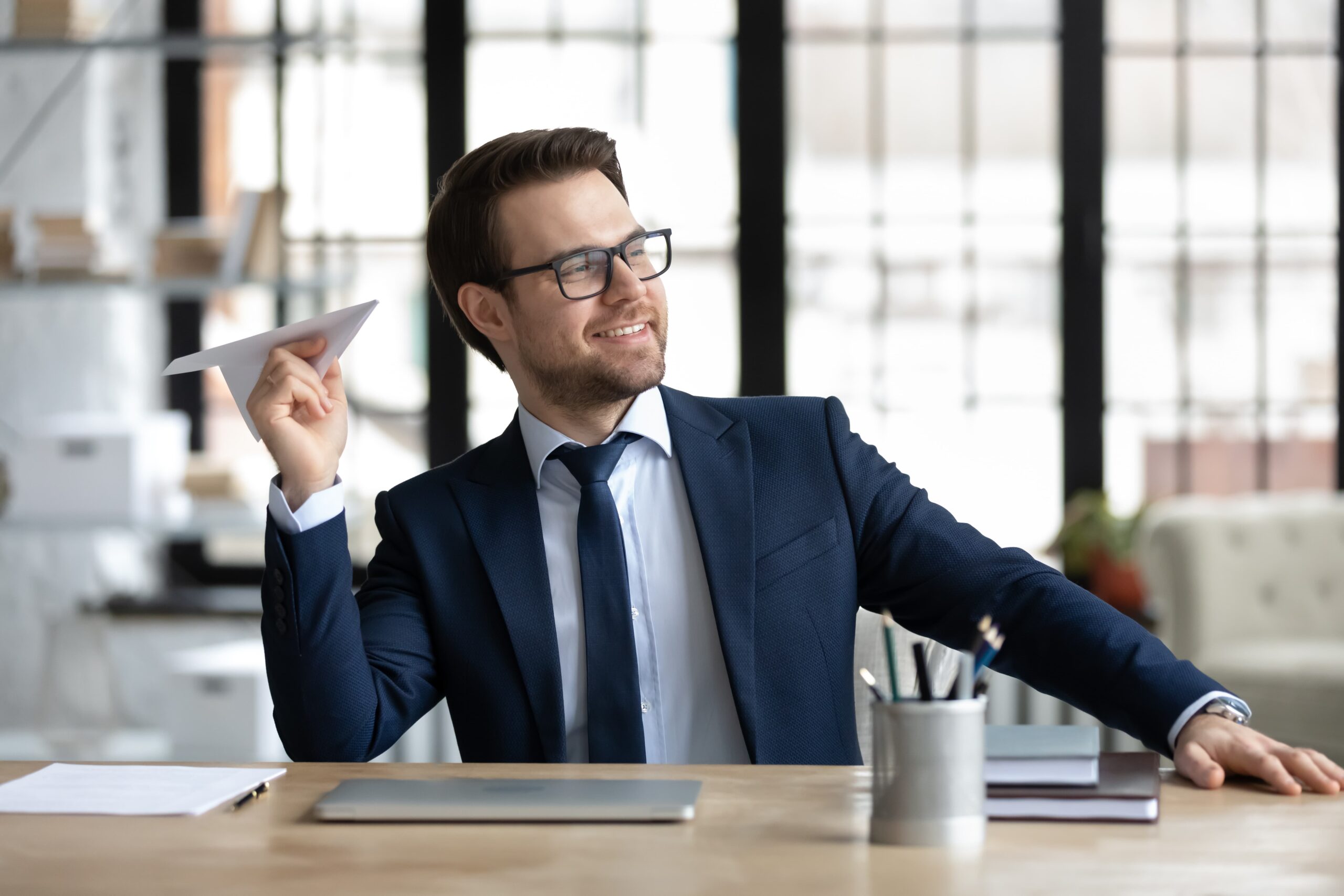 An accountant throws away paper airplanes after a simple job with bookkeeping